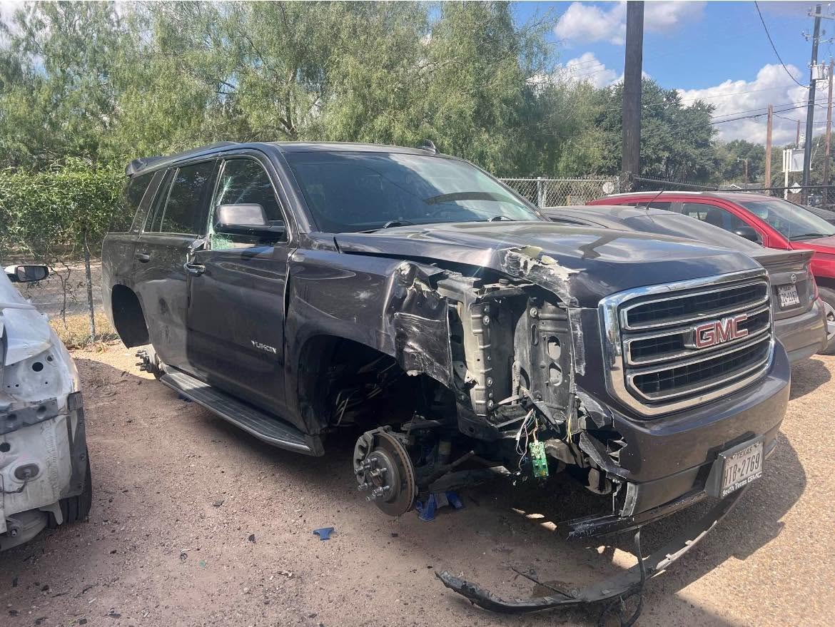 GMC Yukon with severe front passenger-side collision damage before repair