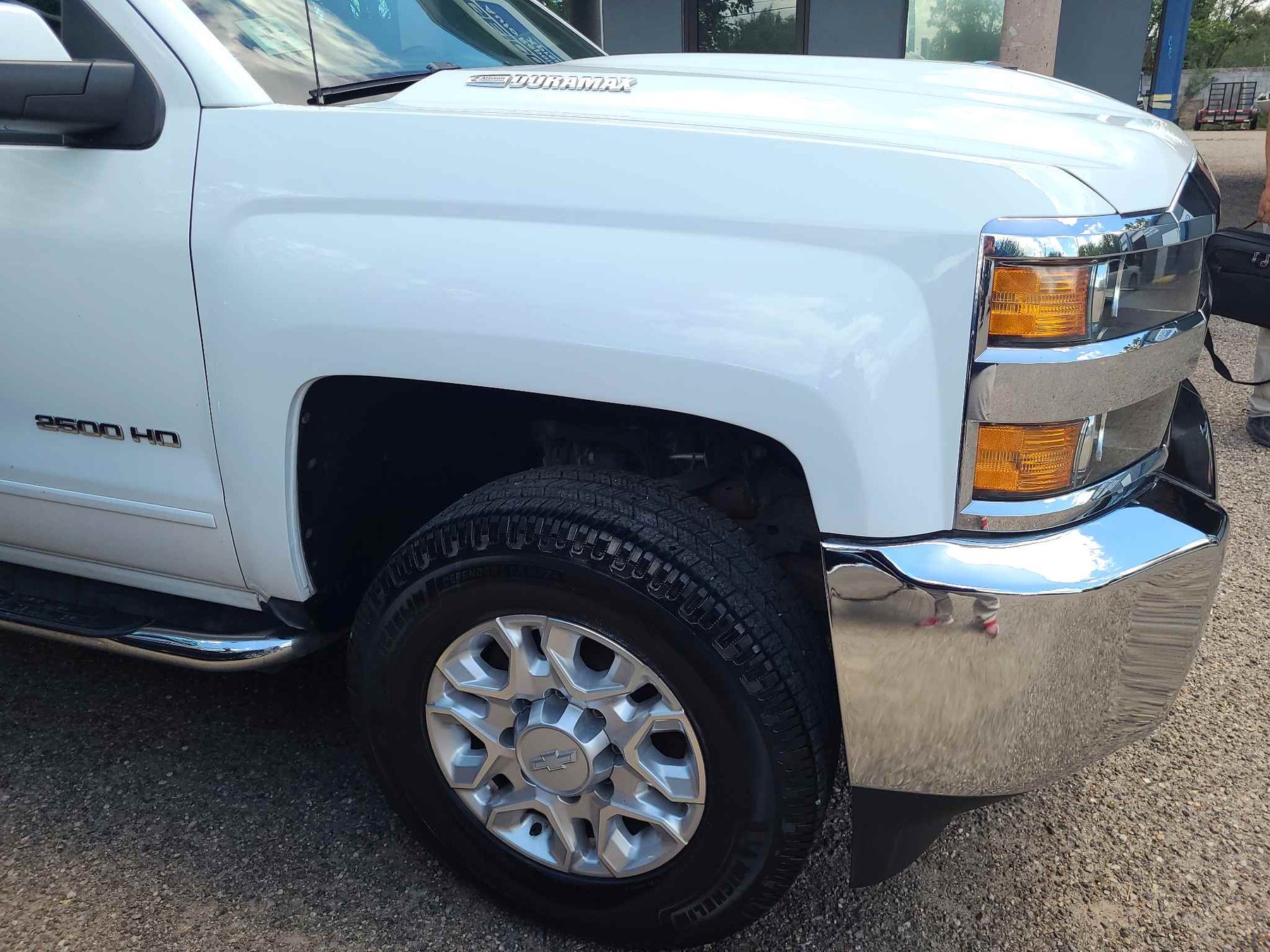White Chevrolet Silverado HD restored after front-fender and bumper repair