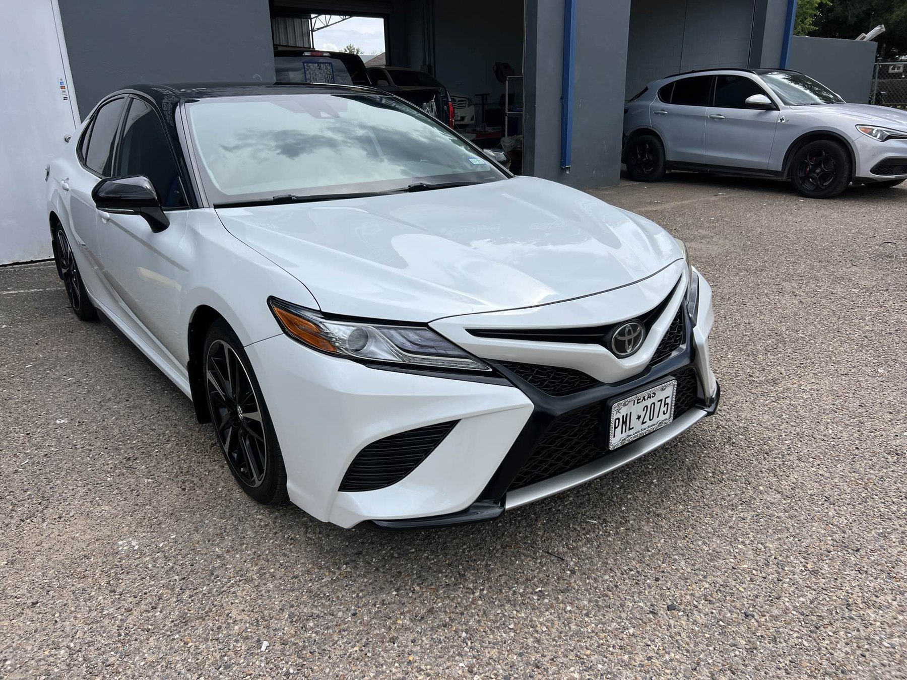 White Toyota Camry restored after front-end collision repair